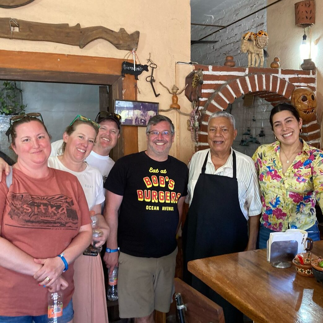 Group of guests pose with owners of Gorditas Lolita in Puerto Vallarta