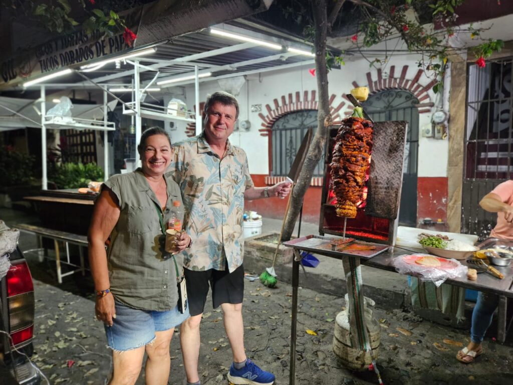 Guests pose with traditional trompo for tacos al pastor