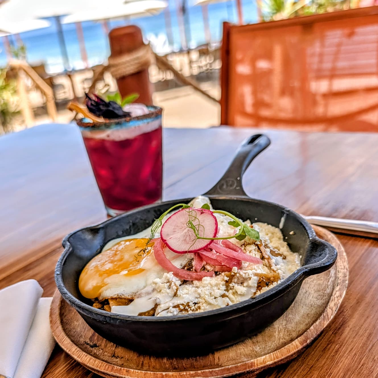 Chilaquiles with green salsa and fried egg with jamaica margarita